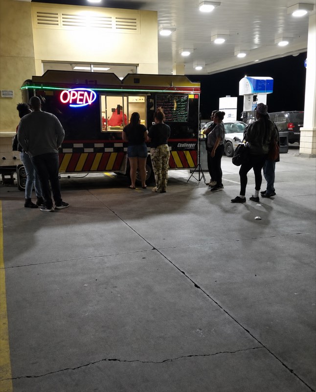 Taste My City food truck serving customers at night